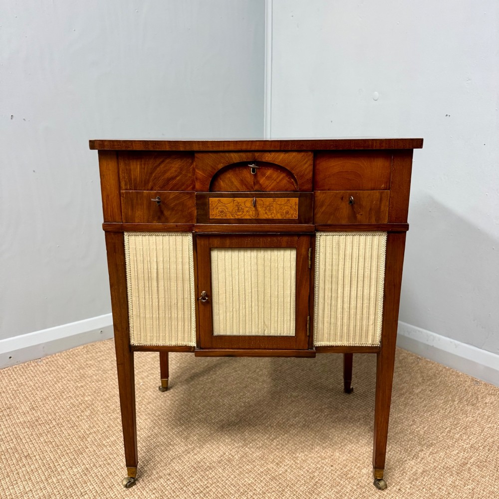 A late Georgian mahogany work table with an open hinged lid revealing fitted interior compartments, pleated fabric side panels, and square tapered legs on brass castors. View III
