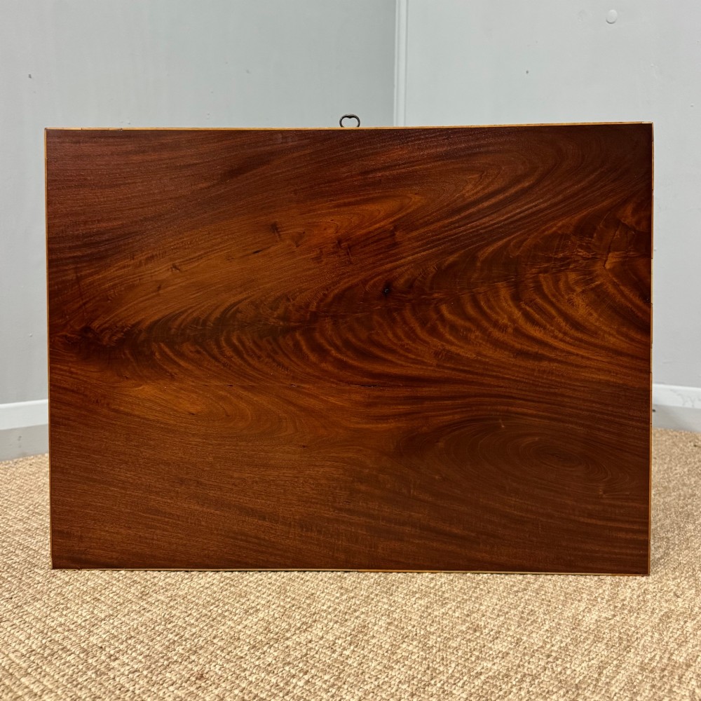 A late Georgian mahogany work table with an open hinged lid revealing fitted interior compartments, pleated fabric side panels, and square tapered legs on brass castors. View IV