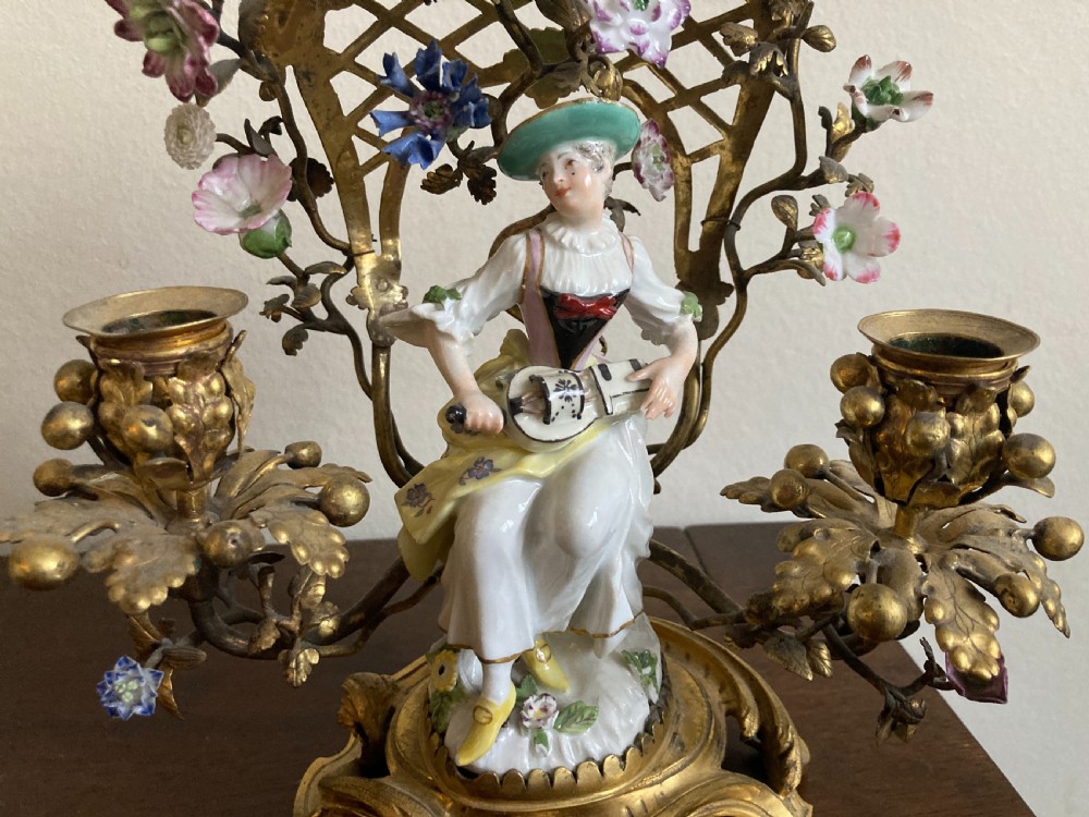 A pair of 18th-century Rococo gilt bronze candelabra featuring seated Meissen porcelain musician figures against floral trellis backdrops. View III