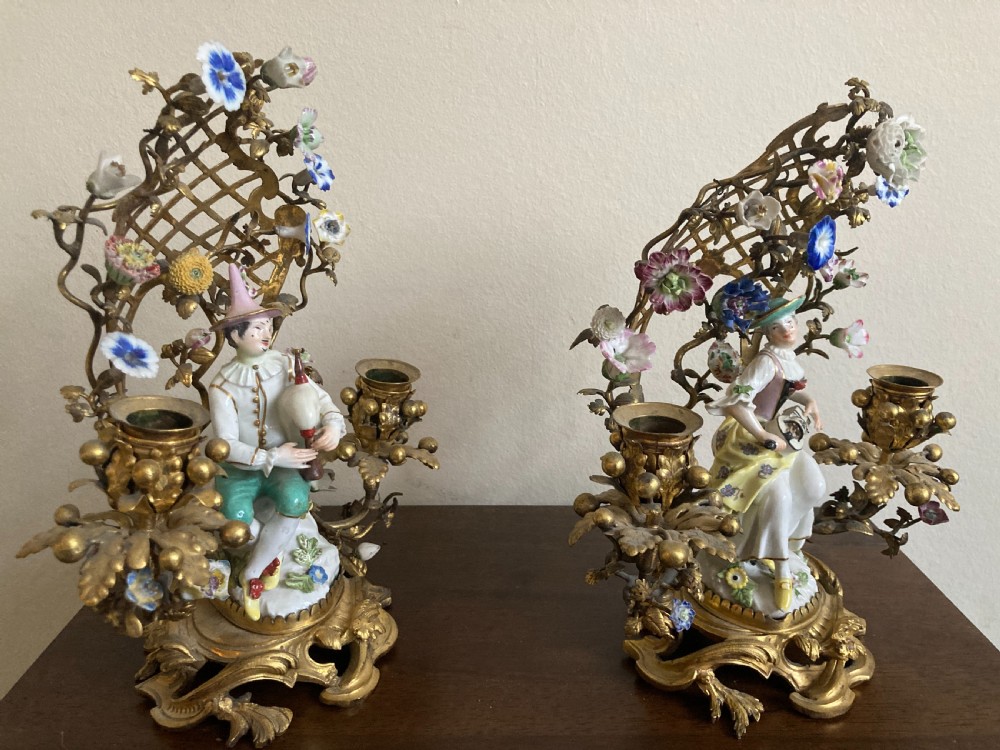 A pair of 18th-century Rococo gilt bronze candelabra featuring seated Meissen porcelain musician figures against floral trellis backdrops. View IV