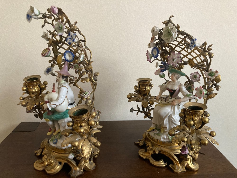 A pair of 18th-century Rococo gilt bronze candelabra featuring seated Meissen porcelain musician figures against floral trellis backdrops. View VIII