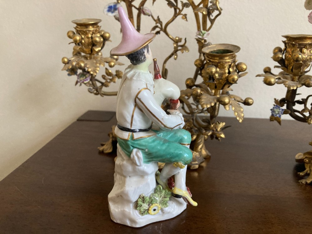 A pair of 18th-century Rococo gilt bronze candelabra featuring seated Meissen porcelain musician figures against floral trellis backdrops. View XI