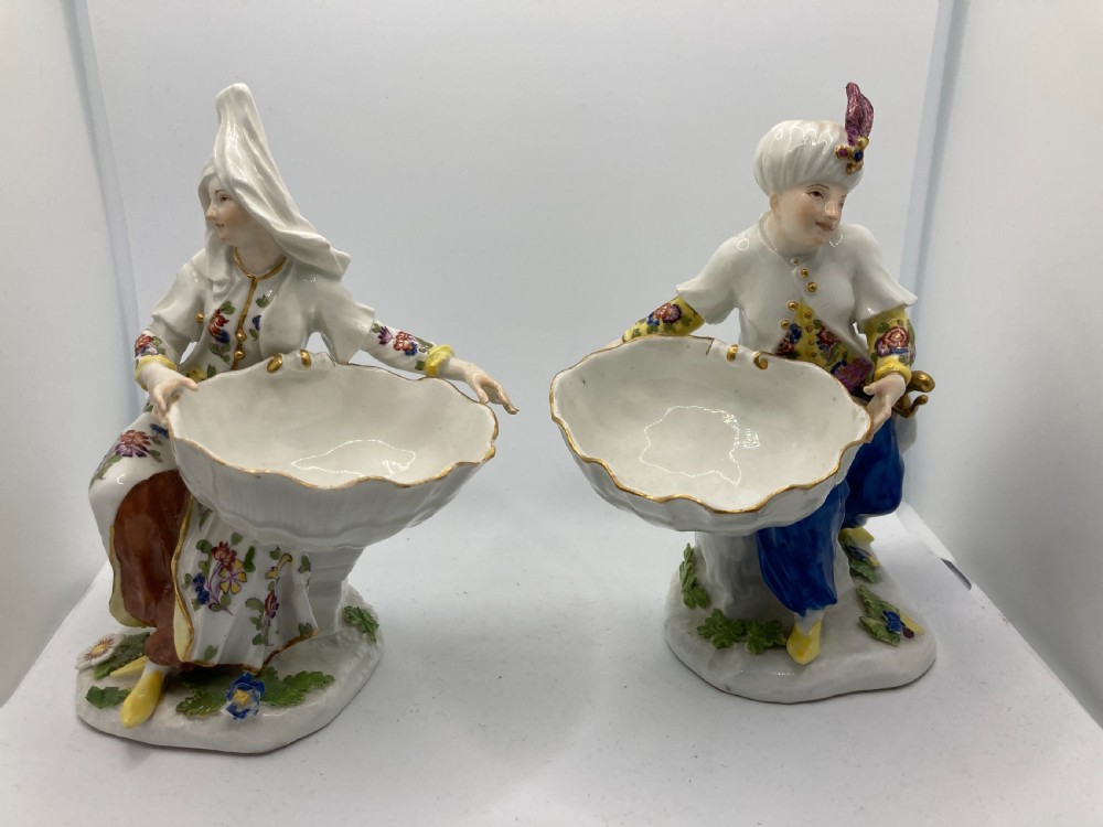 A pair of 18th-century Meissen hard-paste porcelain figures wearing Ottoman garments, each holding a scallop shell-shaped dish. View II