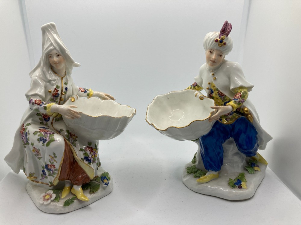 A pair of 18th-century Meissen hard-paste porcelain figures wearing Ottoman garments, each holding a scallop shell-shaped dish. View III