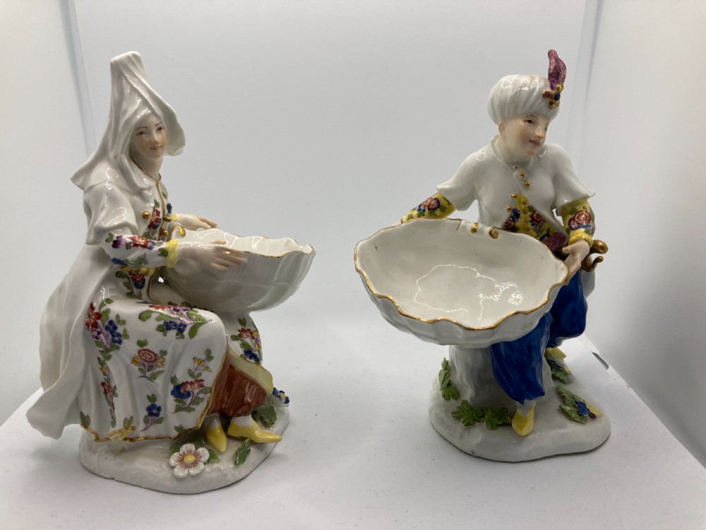 A pair of 18th-century Meissen hard-paste porcelain figures wearing Ottoman garments, each holding a scallop shell-shaped dish. View V