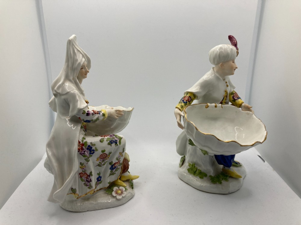 A pair of 18th-century Meissen hard-paste porcelain figures wearing Ottoman garments, each holding a scallop shell-shaped dish. View VI