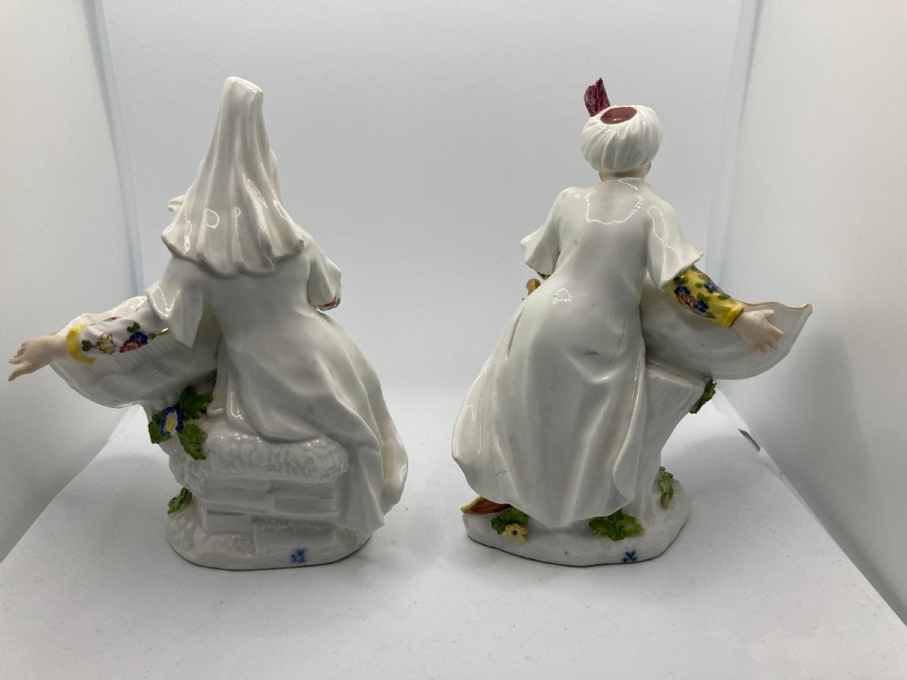 A pair of 18th-century Meissen hard-paste porcelain figures wearing Ottoman garments, each holding a scallop shell-shaped dish. View VIII