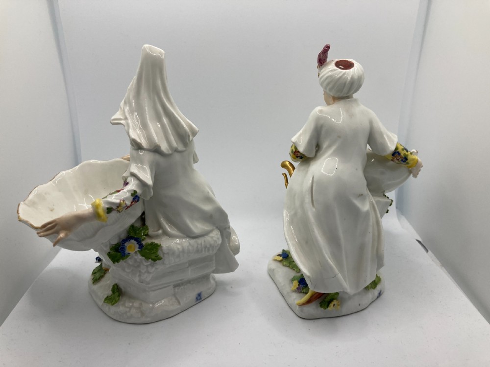 A pair of 18th-century Meissen hard-paste porcelain figures wearing Ottoman garments, each holding a scallop shell-shaped dish. View IX
