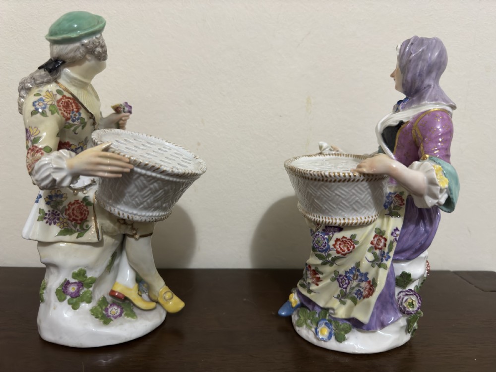 A pair of 18th-century Meissen hard-paste porcelain figures of a seated man and woman holding lattice-patterned basket flower holders with pierced tops. View VIII