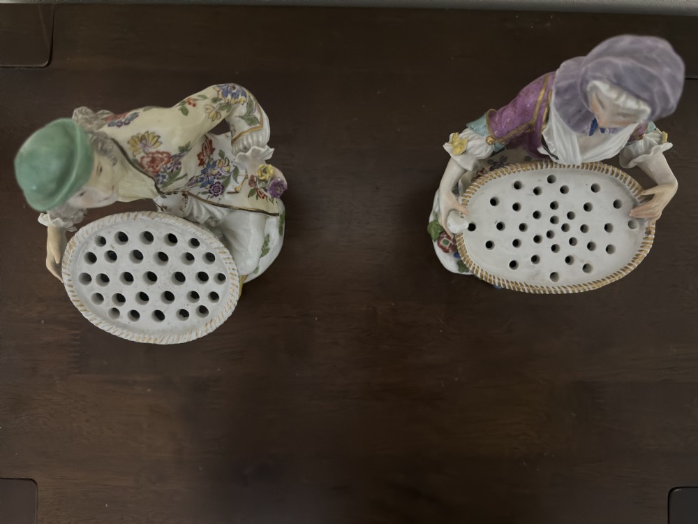 A pair of 18th-century Meissen hard-paste porcelain figures of a seated man and woman holding lattice-patterned basket flower holders with pierced tops. View XI
