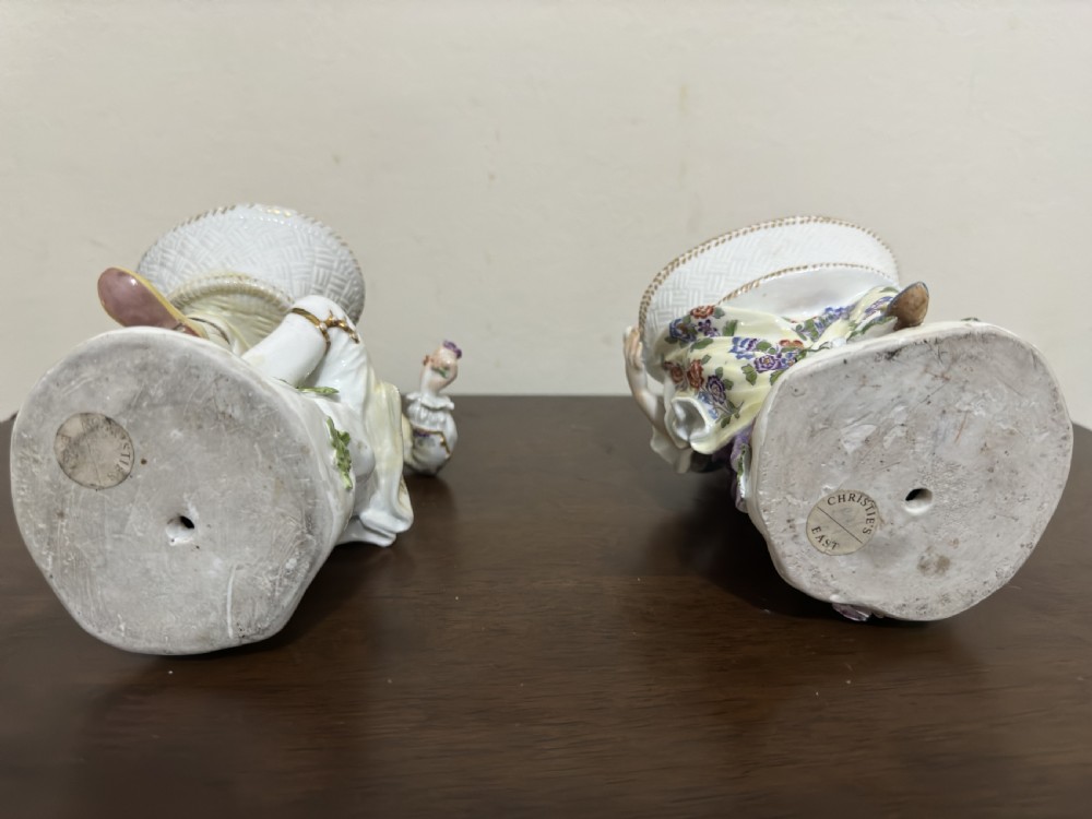 A pair of 18th-century Meissen hard-paste porcelain figures of a seated man and woman holding lattice-patterned basket flower holders with pierced tops. View XII