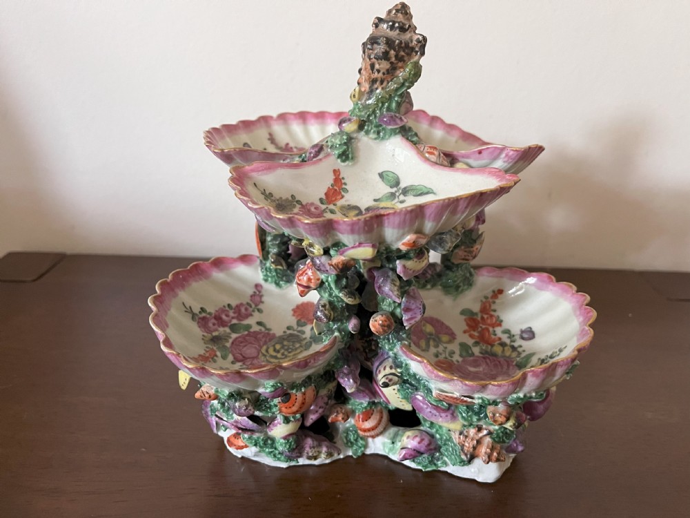 A multi-tiered 18th-century porcelain sweetmeat stand composed of shell-shaped dishes supported by a column encrusted with miniature shells and painted with floral motifs. View III