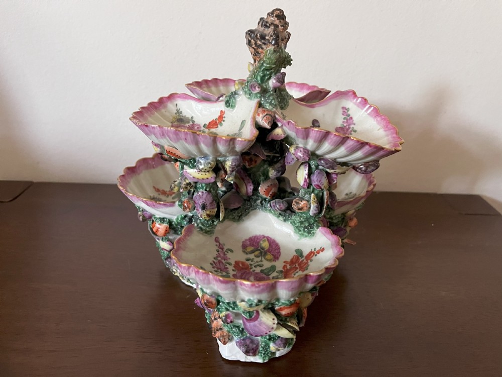 A multi-tiered 18th-century porcelain sweetmeat stand composed of shell-shaped dishes supported by a column encrusted with miniature shells and painted with floral motifs. View IV