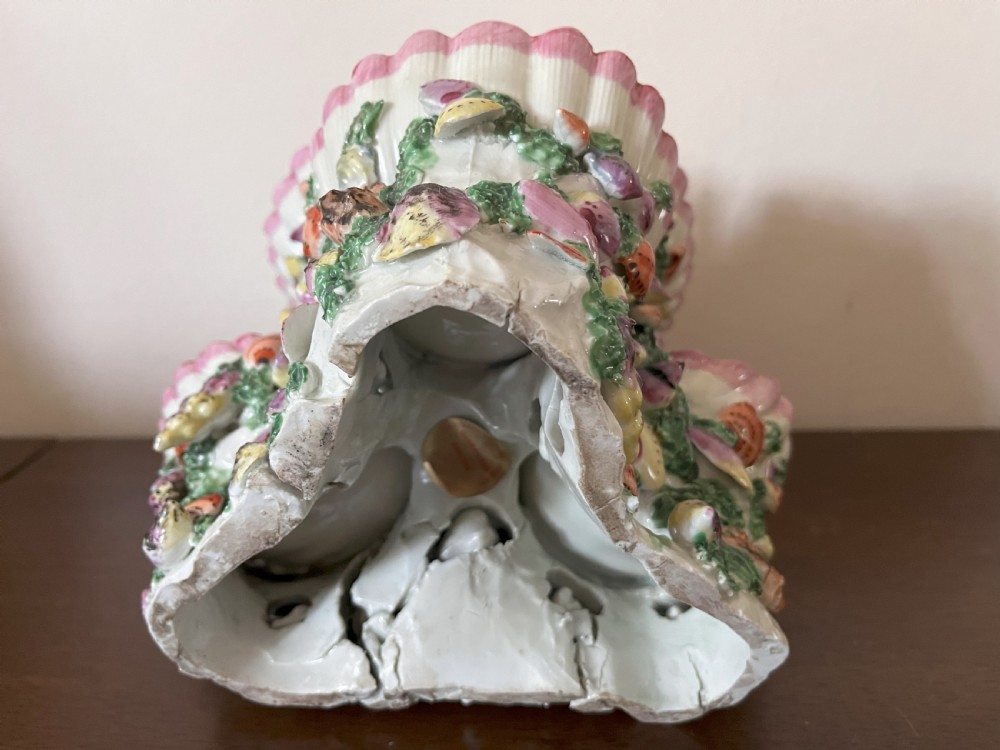 A multi-tiered 18th-century porcelain sweetmeat stand composed of shell-shaped dishes supported by a column encrusted with miniature shells and painted with floral motifs. View IX