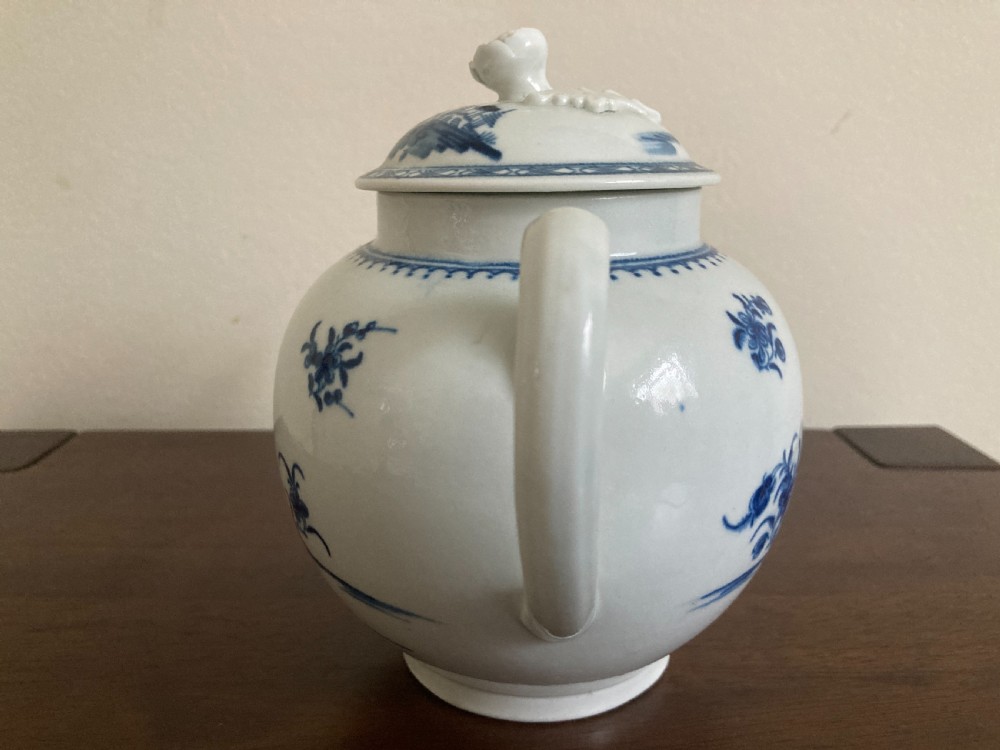 An 18th-century First Period Worcester blue and white soft-paste porcelain teapot featuring a painted chinoiserie figure, domed lid, and floral knop. View VIII