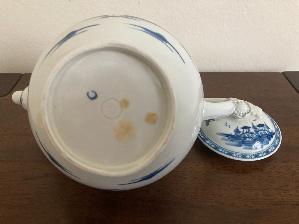 An 18th-century First Period Worcester blue and white soft-paste porcelain teapot featuring a painted chinoiserie figure, domed lid, and floral knop. View XVI