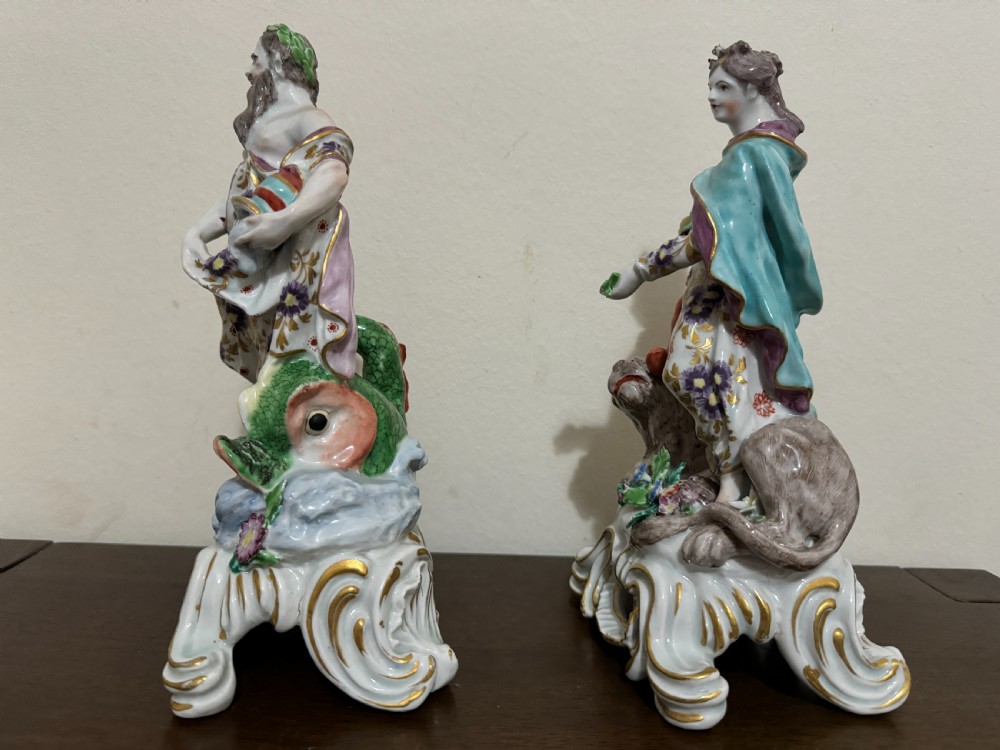 A pair of 18th-century polychrome porcelain allegorical figures depicting Water and Land resting on gilded Rococo scroll bases. View V