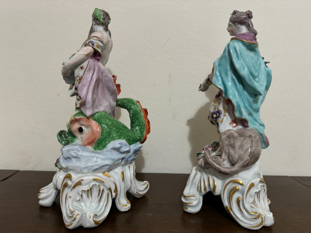 A pair of 18th-century polychrome porcelain allegorical figures depicting Water and Land resting on gilded Rococo scroll bases. View VI