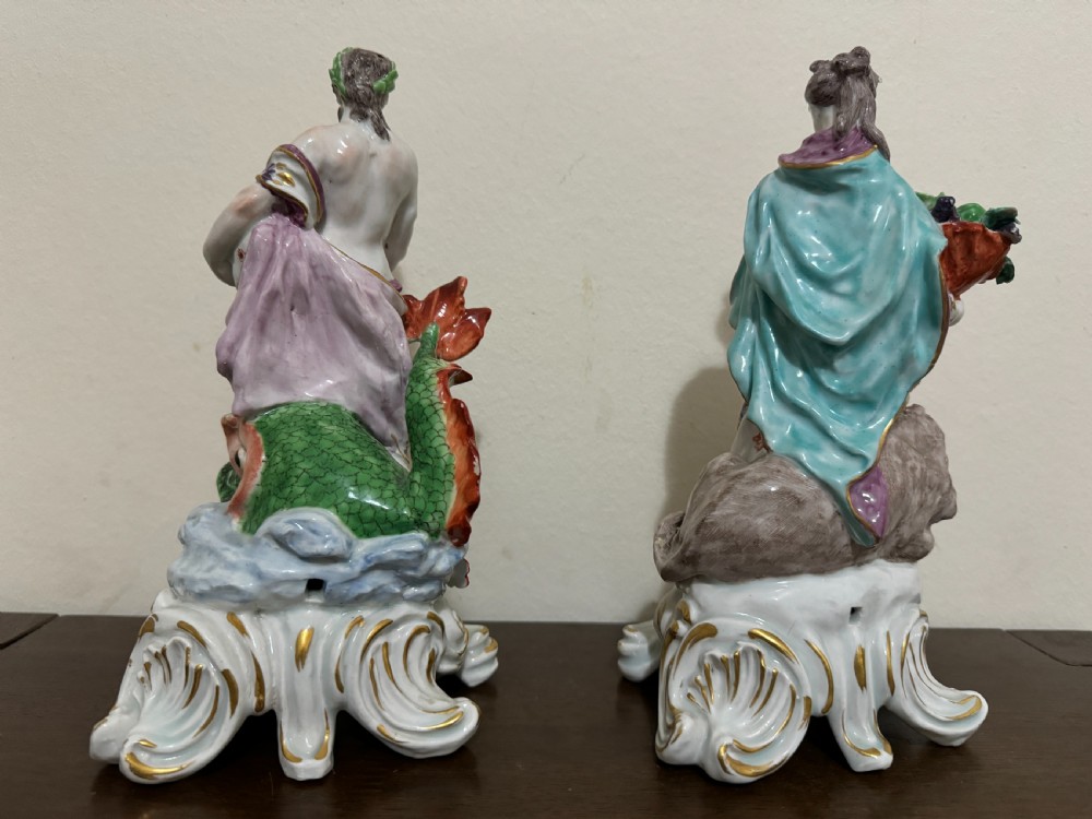 A pair of 18th-century polychrome porcelain allegorical figures depicting Water and Land resting on gilded Rococo scroll bases. View VII