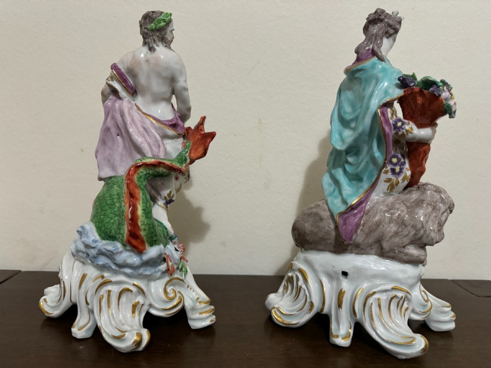 A pair of 18th-century polychrome porcelain allegorical figures depicting Water and Land resting on gilded Rococo scroll bases. View VIII
