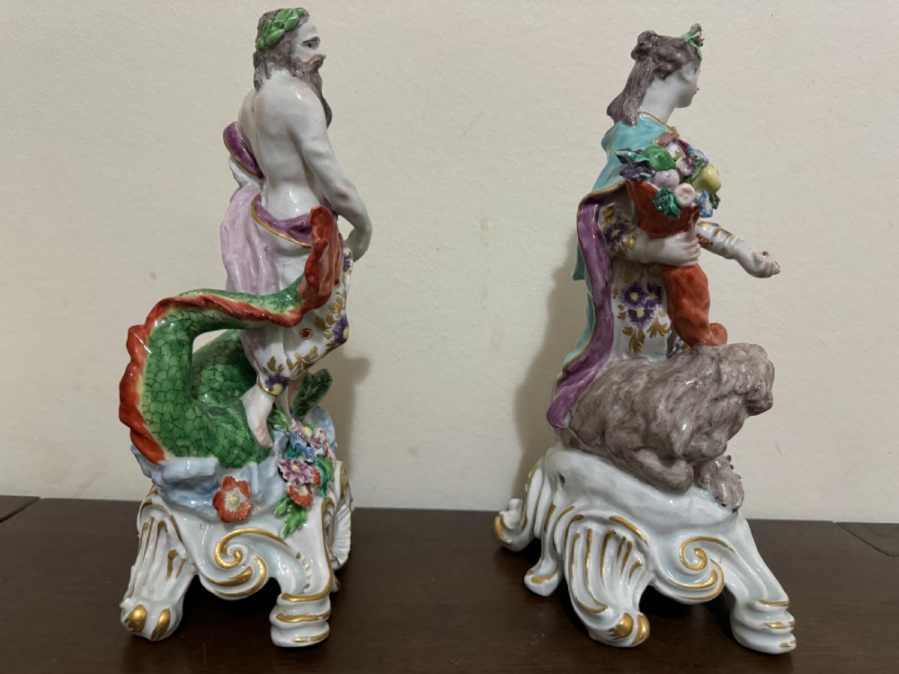 A pair of 18th-century polychrome porcelain allegorical figures depicting Water and Land resting on gilded Rococo scroll bases. View IX