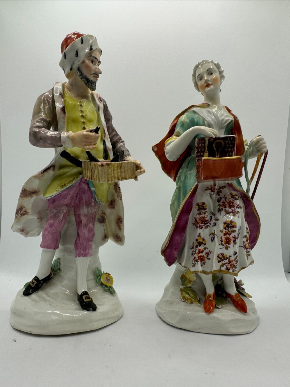 PAIR OF DERBY FIGURES OF 'JEWISH PEDLAR AND COMPANION' , CIRCA 1760