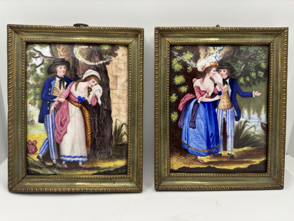A pair of rectangular Georgian polychrome enamel plaques depicting romantic maritime figure scenes framed in beaded gilt metal borders.