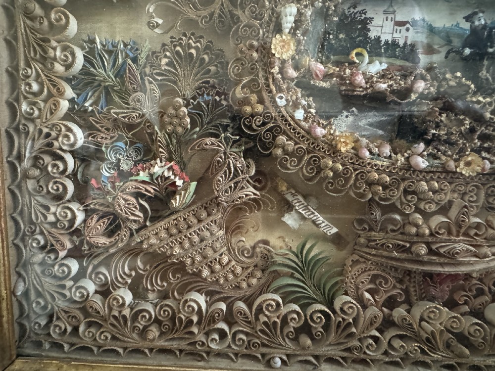 An 18th-century French giltwood framed shadow box containing intricate paperoles scrollwork surrounding a central miniature landscape with Nevers glass figures. View VII