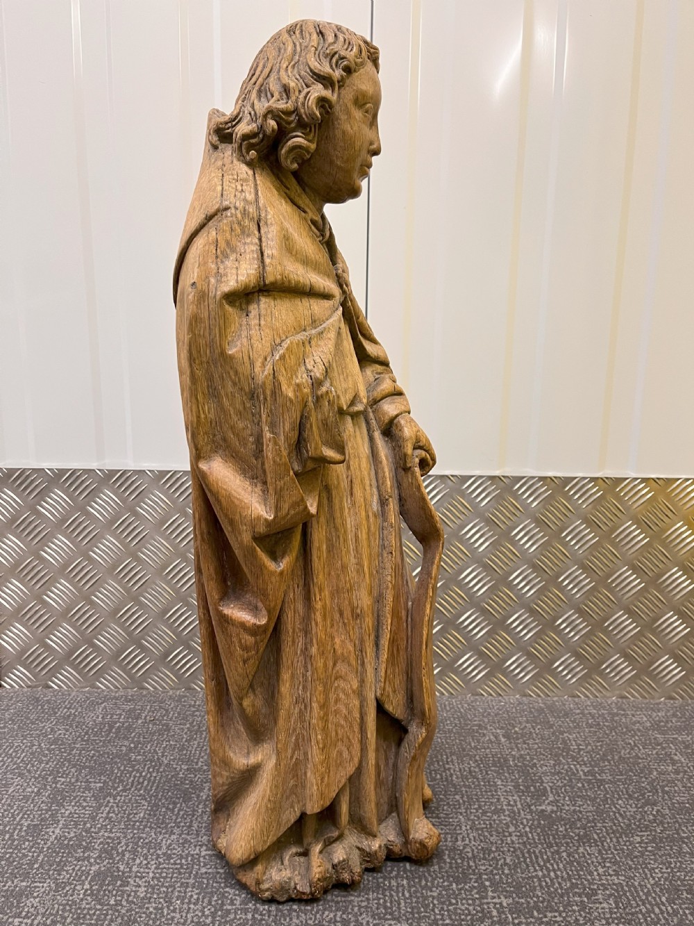 A pair of hand-carved oak sculptures depicting two standing saints in long draped robes. View V