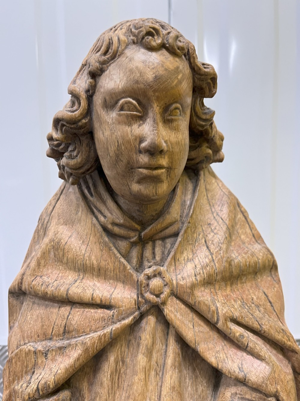 A pair of hand-carved oak sculptures depicting two standing saints in long draped robes. View VI