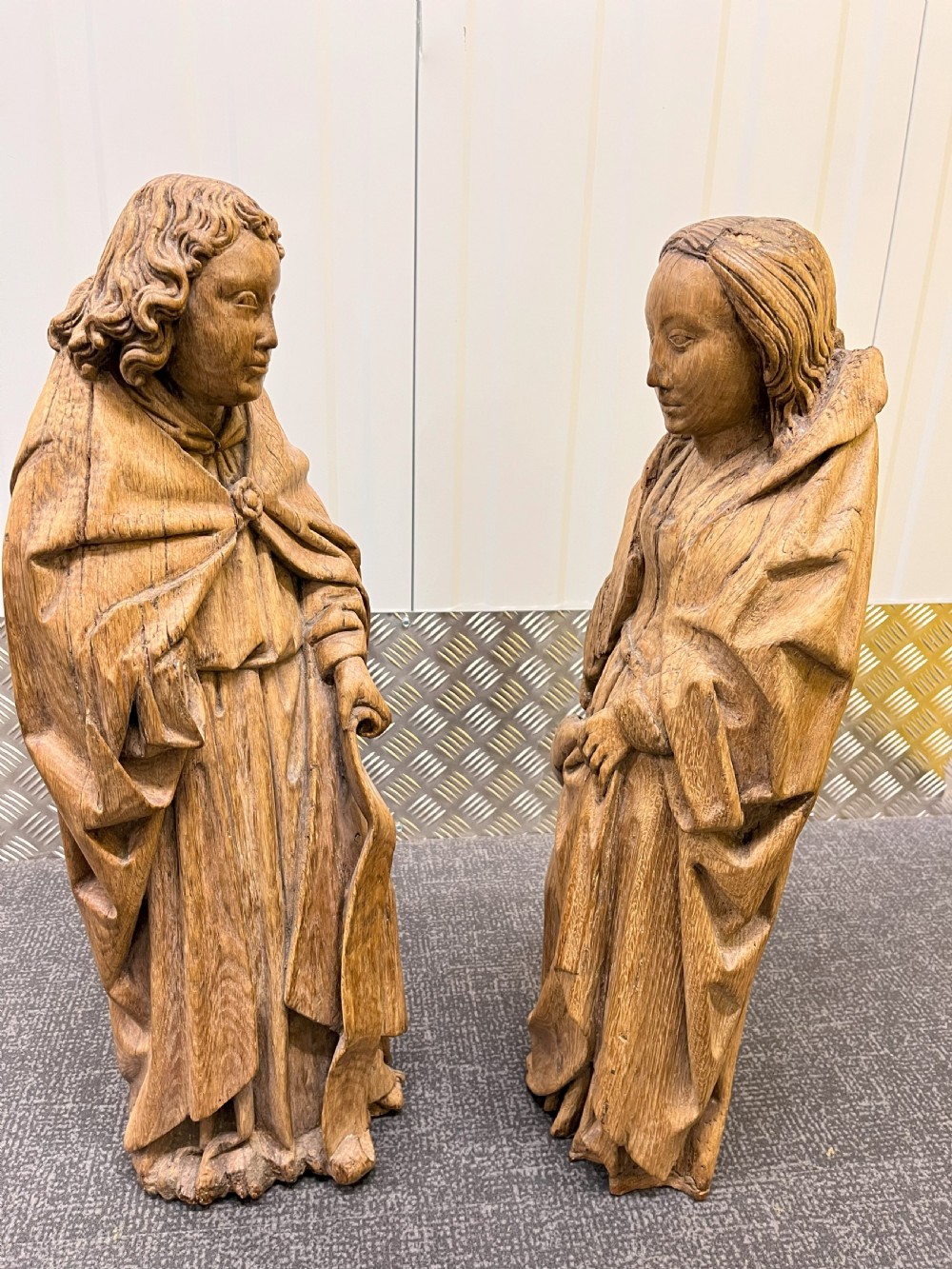 A pair of hand-carved oak sculptures depicting two standing saints in long draped robes. View XIII