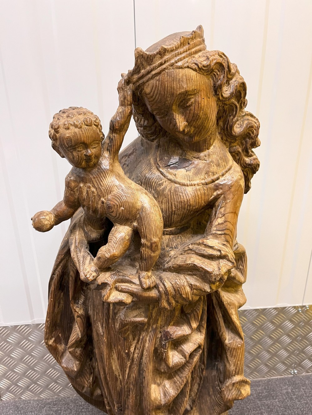 A 19th-century hand-carved wooden statue depicting the crowned Virgin Mary holding the Christ child in detailed draped robes. View III