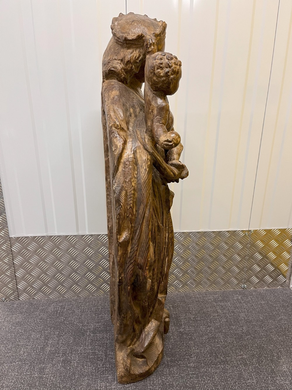 A 19th-century hand-carved wooden statue depicting the crowned Virgin Mary holding the Christ child in detailed draped robes. View IV