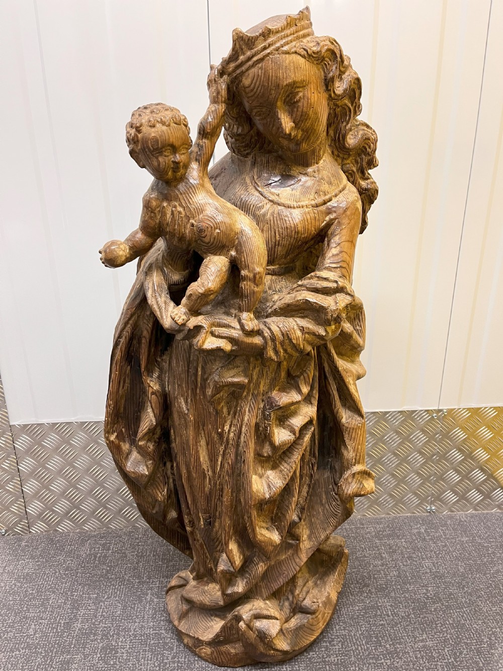 A 19th-century hand-carved wooden statue depicting the crowned Virgin Mary holding the Christ child in detailed draped robes. View VI