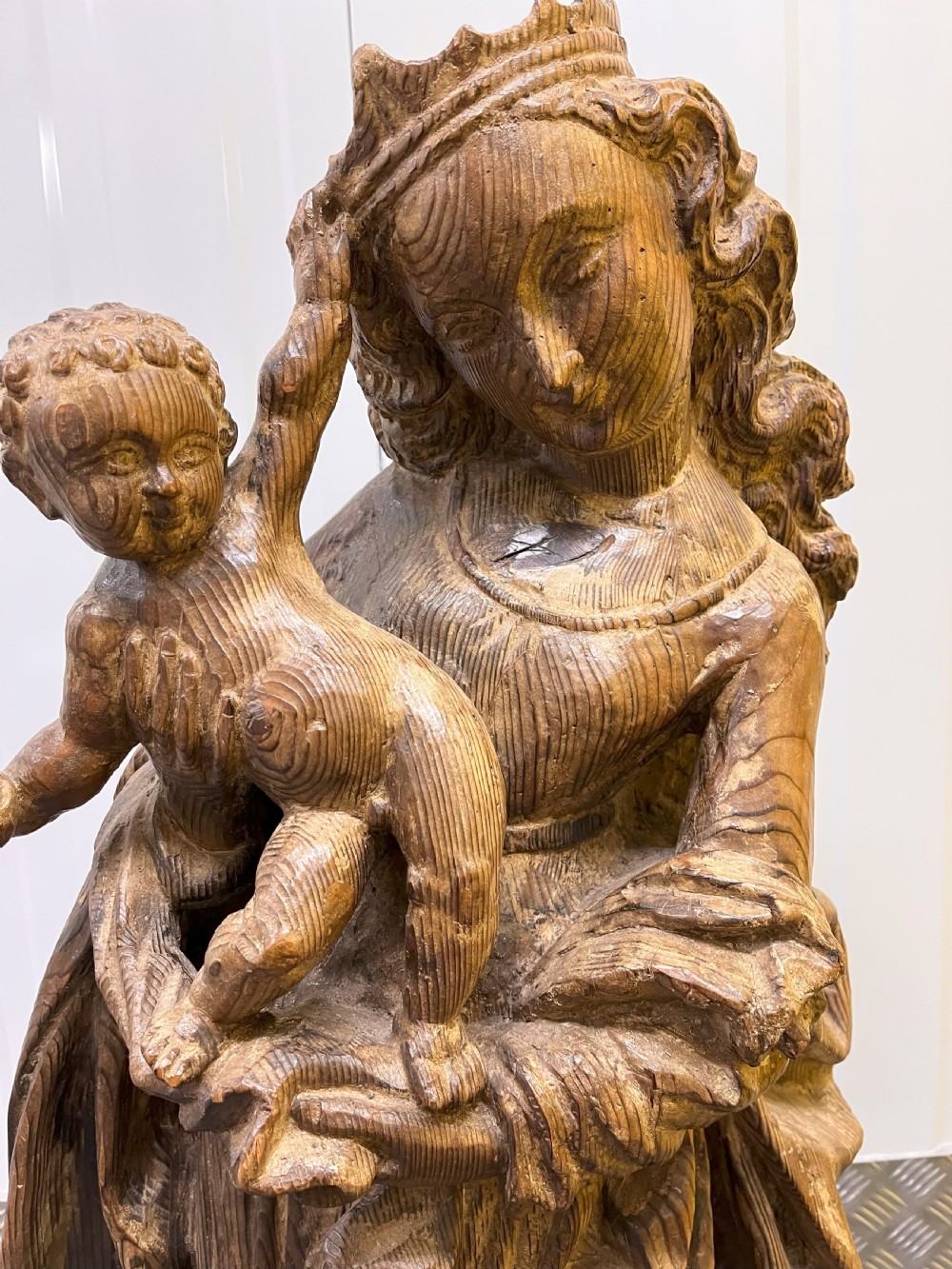 A 19th-century hand-carved wooden statue depicting the crowned Virgin Mary holding the Christ child in detailed draped robes. View VII
