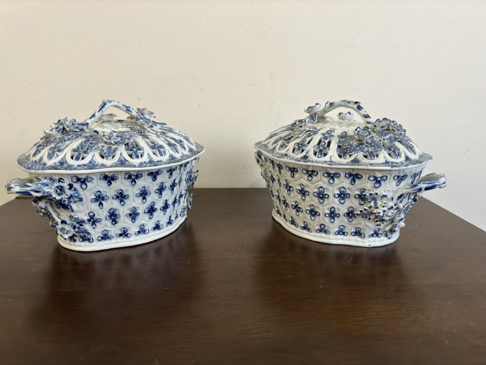 A pair of 18th-century Worcester blue and white porcelain chestnut baskets with reticulated covers, twig handles, and encrusted floral decorations. View II