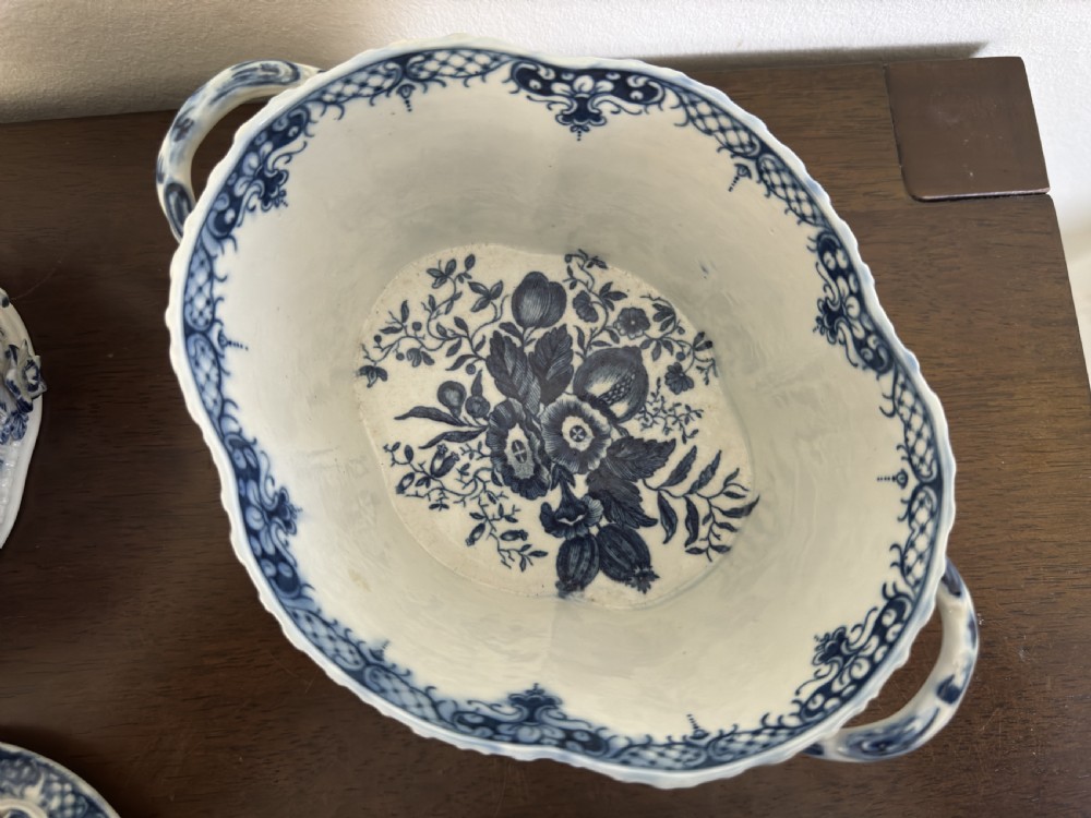 A pair of 18th-century Worcester blue and white porcelain chestnut baskets with reticulated covers, twig handles, and encrusted floral decorations. View VIII
