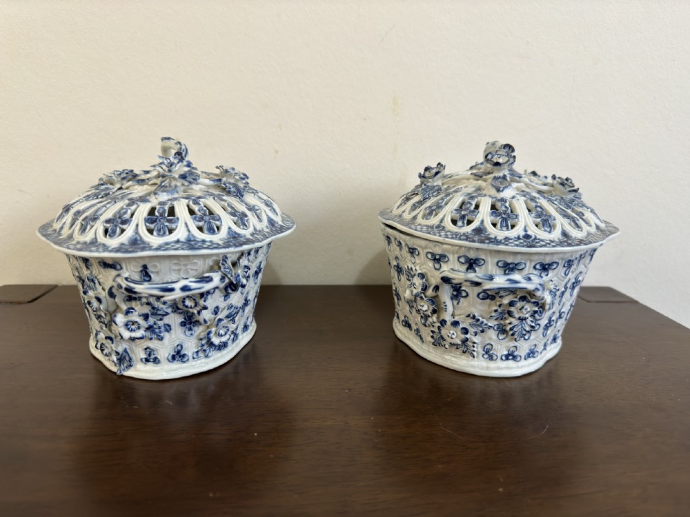 A pair of 18th-century Worcester blue and white porcelain chestnut baskets with reticulated covers, twig handles, and encrusted floral decorations. View XI