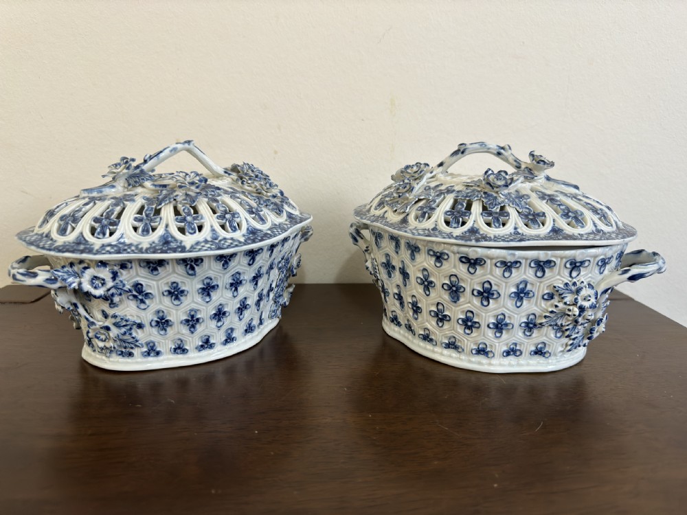 A pair of 18th-century Worcester blue and white porcelain chestnut baskets with reticulated covers, twig handles, and encrusted floral decorations. View XII