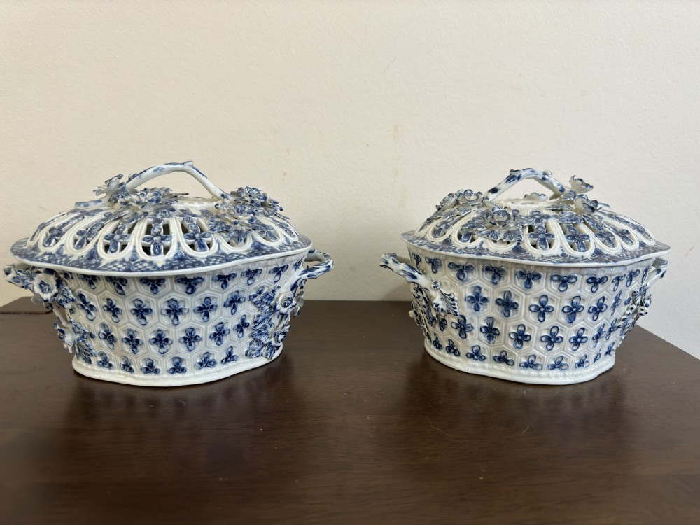 A pair of 18th-century Worcester blue and white porcelain chestnut baskets with reticulated covers, twig handles, and encrusted floral decorations. View XIII