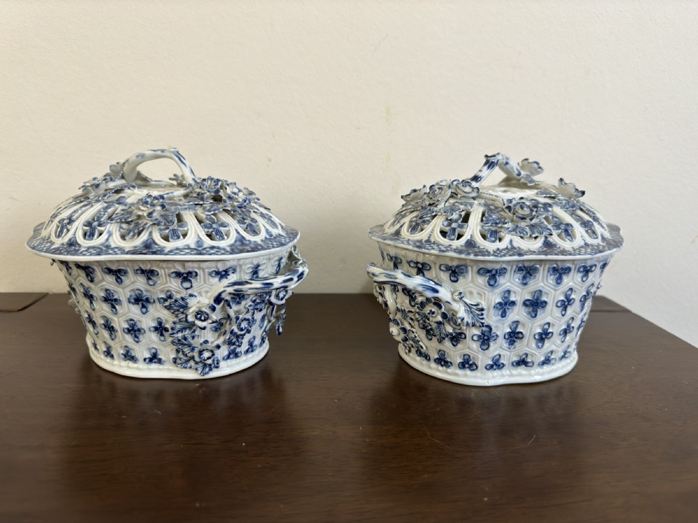A pair of 18th-century Worcester blue and white porcelain chestnut baskets with reticulated covers, twig handles, and encrusted floral decorations. View XIV