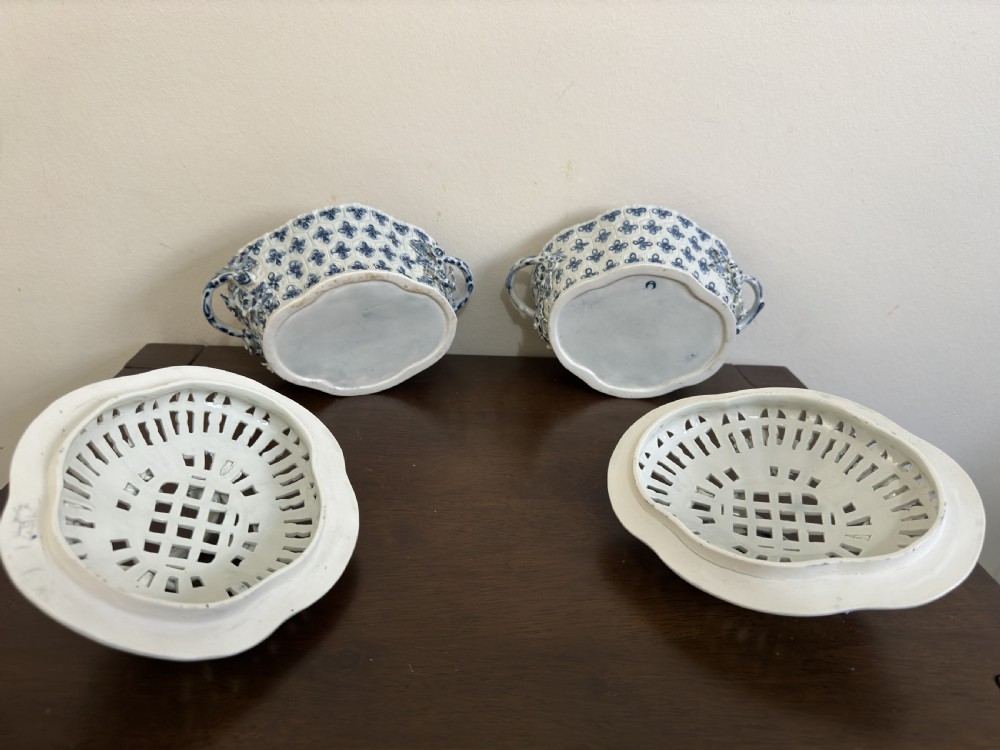 A pair of 18th-century Worcester blue and white porcelain chestnut baskets with reticulated covers, twig handles, and encrusted floral decorations. View XVII