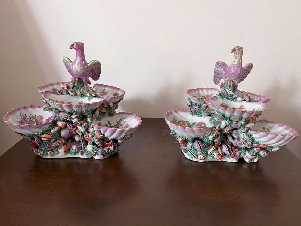 A pair of 18th-century First Period Worcester soft-paste porcelain tiered centrepieces featuring moulded shell dishes, encrusted marine decoration, and bird finials in pink and green enamels. View II