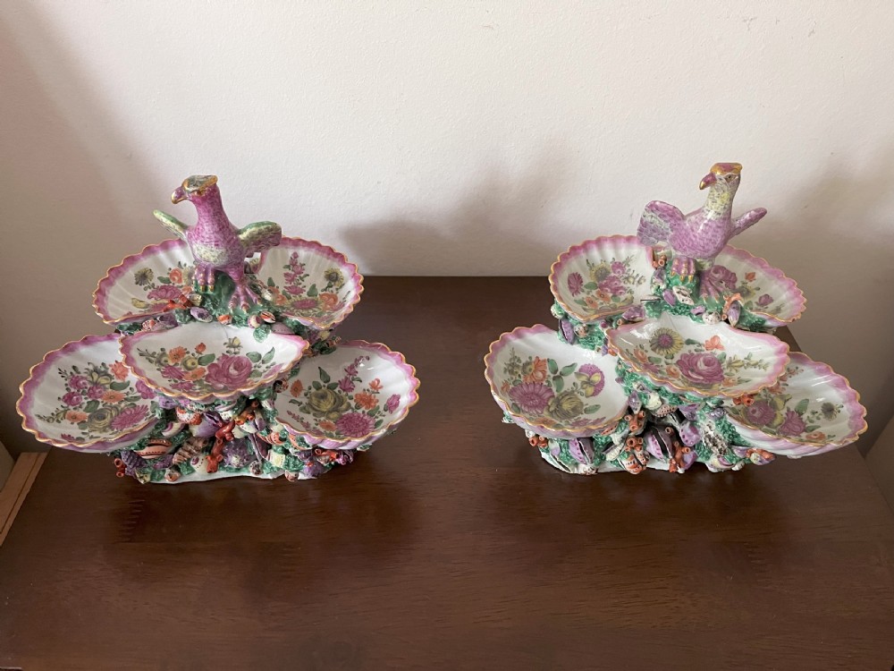 A pair of 18th-century First Period Worcester soft-paste porcelain tiered centrepieces featuring moulded shell dishes, encrusted marine decoration, and bird finials in pink and green enamels. View III
