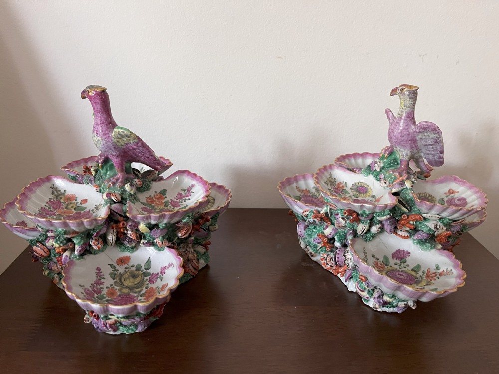 A pair of 18th-century First Period Worcester soft-paste porcelain tiered centrepieces featuring moulded shell dishes, encrusted marine decoration, and bird finials in pink and green enamels. View IV