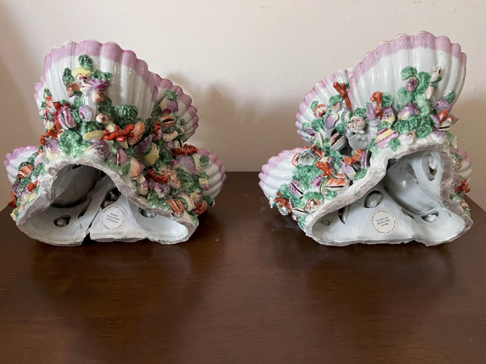 A pair of 18th-century First Period Worcester soft-paste porcelain tiered centrepieces featuring moulded shell dishes, encrusted marine decoration, and bird finials in pink and green enamels. View XII