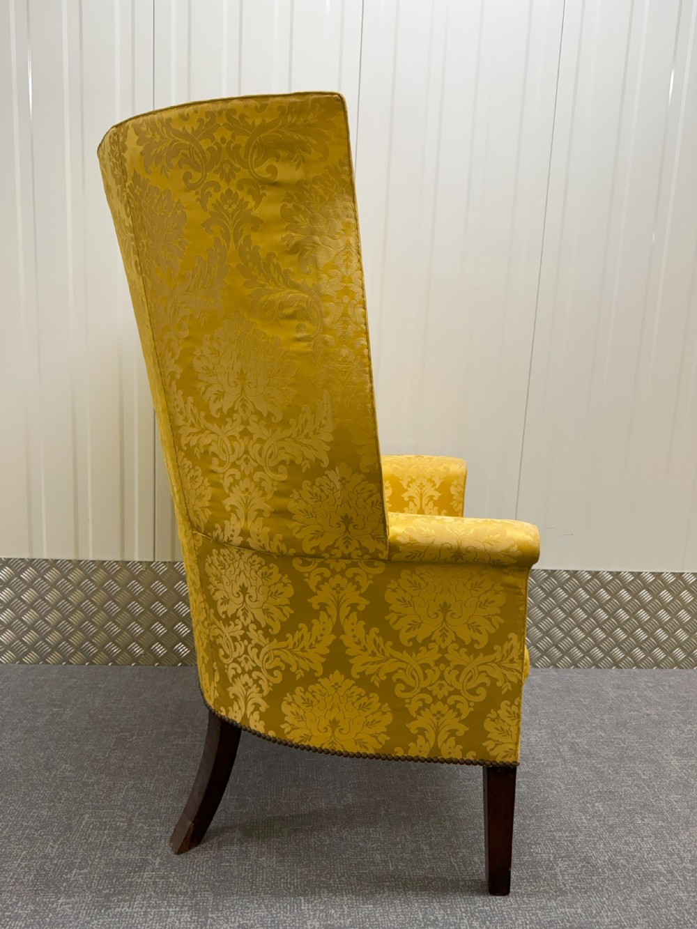 A Georgian mahogany wingback armchair featuring yellow damask patterned upholstery, a channel-fluted backrest, and straight dark wood legs. View II