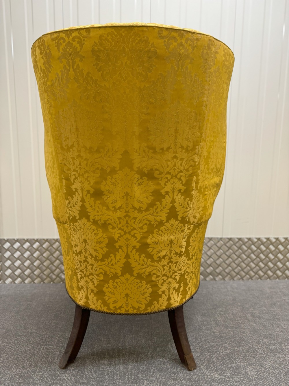 A Georgian mahogany wingback armchair featuring yellow damask patterned upholstery, a channel-fluted backrest, and straight dark wood legs. View III