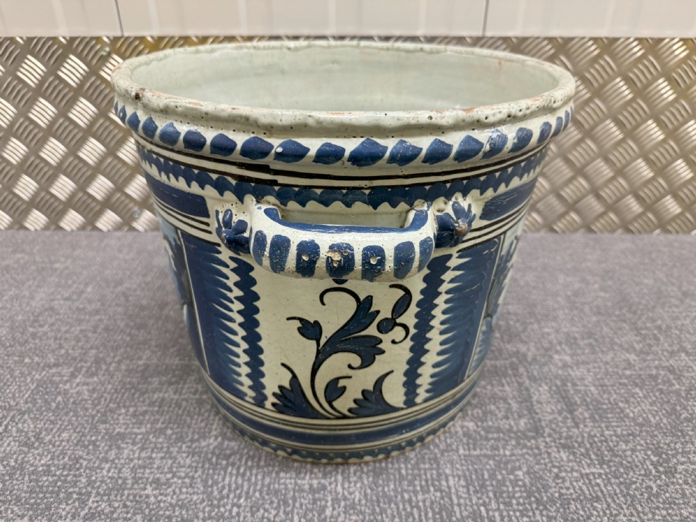 An 18th-century French Nevers faience ceramic orange pot decorated with hand-painted cobalt blue landscape motifs, geometric borders, and twin side handles. View II