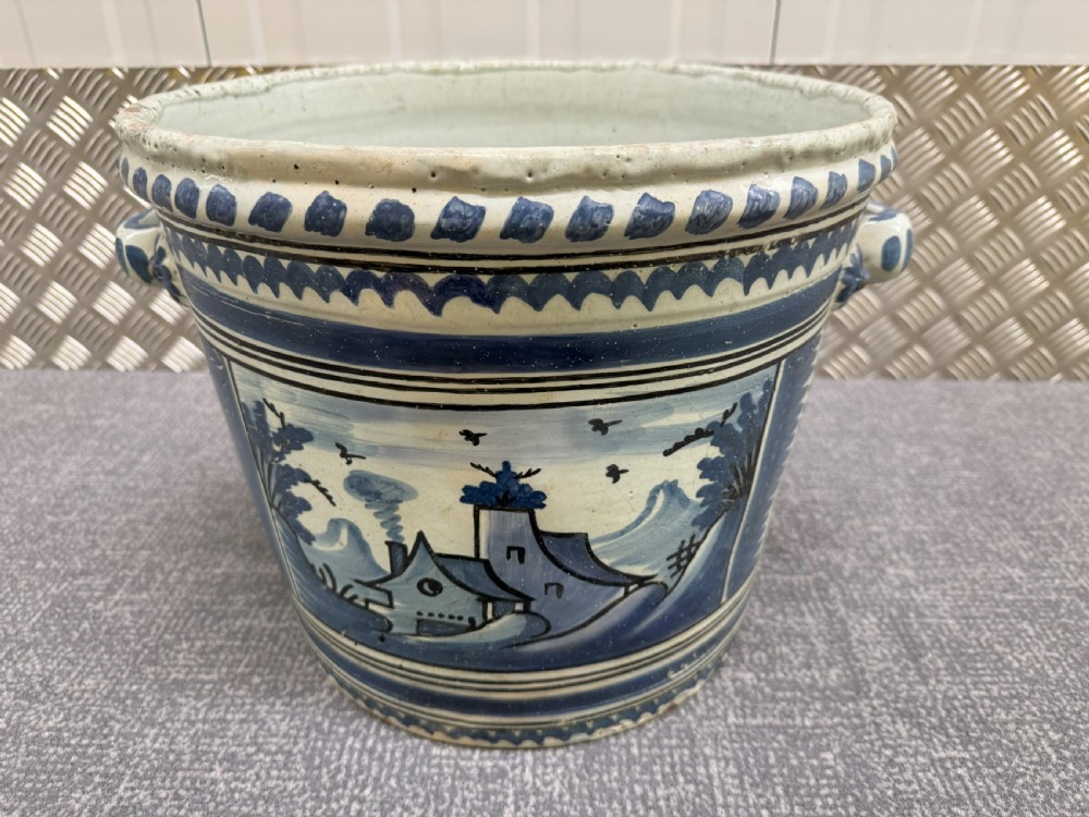 An 18th-century French Nevers faience ceramic orange pot decorated with hand-painted cobalt blue landscape motifs, geometric borders, and twin side handles. View III